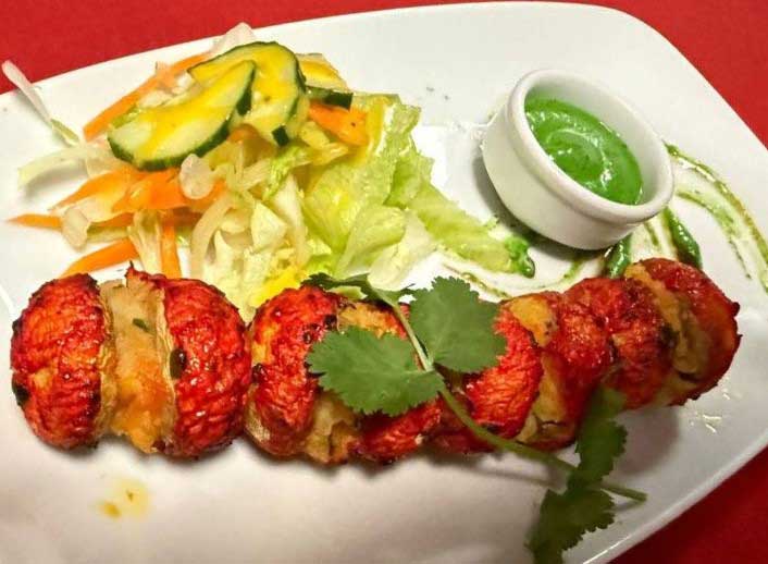 Succulent tandoori chicken pieces served with fresh salad and dipping sauce at The Dine restaurant in Broxburn.